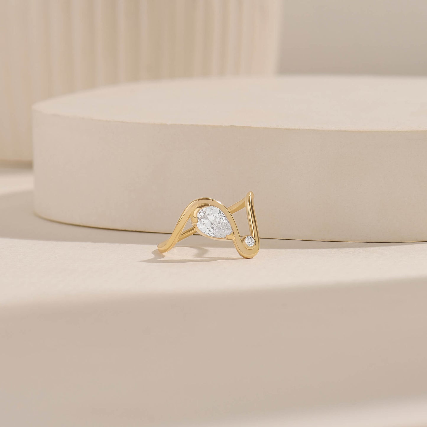 Moissanite Pear Solitaire Swirl Ring in Gold