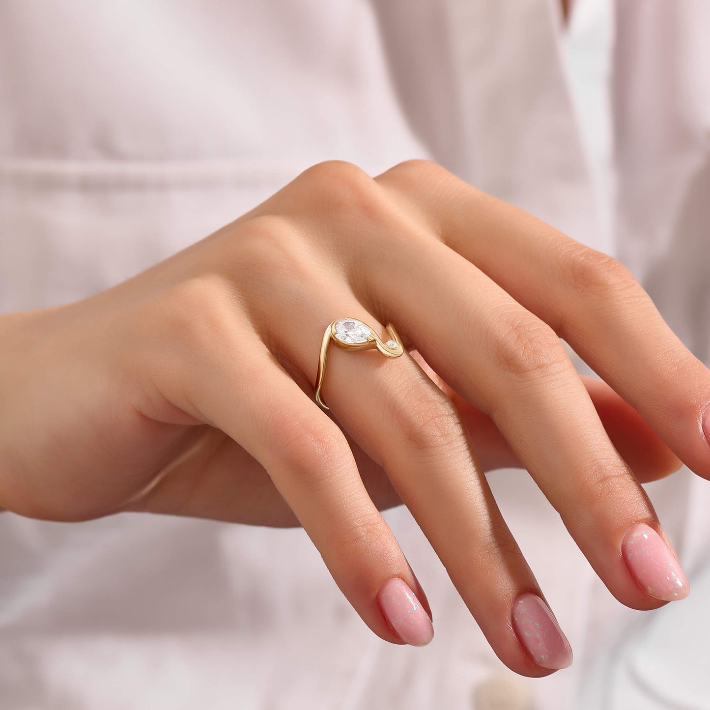 Moissanite Pear Solitaire Swirl Ring in Gold